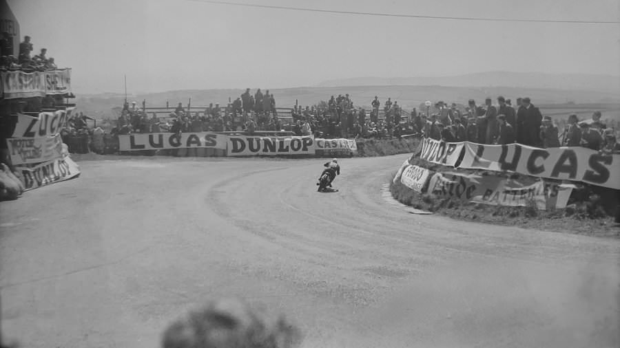 Bill Doran (#68) passes through Creg-ny-Baa past the hotel with crowds seen on every side of the road